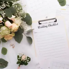 Un bouquet de roses, des alliances, un parfum et une liste de contrôle pour l'organisation mariage soi-même.