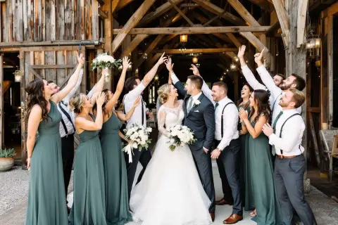 La mariée et son cortège de demoiselles d'honneur célèbrent joyeusement leur mariage dans une grange rustique.