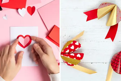 Création d'un cadeau Saint Valentin DIY : mains assemblant un cœur en papier sur une carte, et des nœuds décoratifs rouges et dorés.