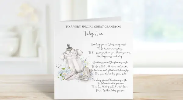 Carte de baptême pour Toby Joe, avec une tenue de bébé et des fleurs bleues. Un doux message de baptême pour un petit-fils.